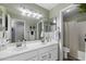 Bright bathroom with dual sinks, a large mirror, and ample counter space at 2111 E Rawhide St, Gilbert, AZ 85296