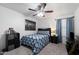 Cozy bedroom with a ceiling fan, comfortable bed, and ample storage at 2111 E Rawhide St, Gilbert, AZ 85296
