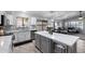 Open kitchen with stainless appliances, white cabinets, quartz countertops and gray island at 2111 E Rawhide St, Gilbert, AZ 85296