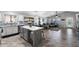 Open concept kitchen with island and built-in beverage cooler flowing into the living room at 2111 E Rawhide St, Gilbert, AZ 85296