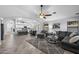 Open-concept living room and kitchen area, perfect for entertaining, with a stylish gray sectional at 2111 E Rawhide St, Gilbert, AZ 85296