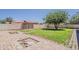 Expansive backyard with patio area, mature tree, block wall, and gate, perfect for outdoor activities at 2130 W Cindy St, Chandler, AZ 85224