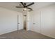 Bedroom with neutral carpet, ceiling fan and double door closet at 2130 W Cindy St, Chandler, AZ 85224