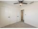 Bright bedroom features neutral carpeting, a ceiling fan, and ample closet space at 2130 W Cindy St, Chandler, AZ 85224