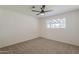 This cozy bedroom is bright with a large window and ceiling fan at 2130 W Cindy St, Chandler, AZ 85224
