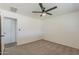 This cozy bedroom is carpeted with a ceiling fan and closet space at 2130 W Cindy St, Chandler, AZ 85224