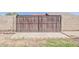 A metal sliding gate providing access to the property, set within a concrete block wall at 2130 W Cindy St, Chandler, AZ 85224