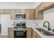 This beautifully renovated kitchen features stainless steel appliances and modern white countertops at 2130 W Cindy St, Chandler, AZ 85224