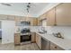 This beautifully renovated kitchen features stainless steel appliances and modern white countertops at 2130 W Cindy St, Chandler, AZ 85224