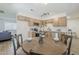 A bright, airy kitchen is shown in the background of this dining room image at 2130 W Cindy St, Chandler, AZ 85224