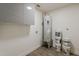 Large laundry room features a gray cabinet, water heater, and wood-look tile flooring at 2130 W Cindy St, Chandler, AZ 85224