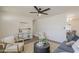 Spacious living room with stylish seating, sleek ceiling fan, and adjacent dining area perfect for entertaining at 2130 W Cindy St, Chandler, AZ 85224
