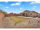 This backyard features a patio, gravel and desert landscaping with a patch of grass at 2264 W Arroyo Way, San Tan Valley, AZ 85144