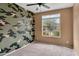 A charming bedroom with plush carpet, a ceiling fan and a view of the neighborhood at 2264 W Arroyo Way, San Tan Valley, AZ 85144