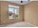 Bedroom featuring plush carpet, a large window, neutral walls, and a ceiling fan at 2264 W Arroyo Way, San Tan Valley, AZ 85144