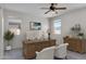 Bright home office with modern desk, matching white chairs, and natural light at 2264 W Arroyo Way, San Tan Valley, AZ 85144