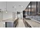 Spacious kitchen features granite countertops, stainless appliances, tile backsplash, and modern pendant lighting at 2264 W Arroyo Way, San Tan Valley, AZ 85144