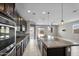 Open-concept kitchen with a large center island, stainless steel appliances, and seamless flow to the dining area at 2264 W Arroyo Way, San Tan Valley, AZ 85144