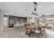 Open concept kitchen and living room with island seating and stainless steel appliances at 2264 W Arroyo Way, San Tan Valley, AZ 85144
