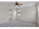 Another view of the spacious main bedroom features a ceiling fan and natural light from the window at 2264 W Arroyo Way, San Tan Valley, AZ 85144