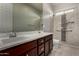 Bathroom with double sink vanity, large mirror, and walk-in shower with marble tile and grab bars at 22944 E Via Del Oro --, Queen Creek, AZ 85142