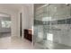 Bright bathroom with walk in shower, dark wood cabinets, and marble tile at 22944 E Via Del Oro --, Queen Creek, AZ 85142