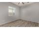 Bedroom featuring tile floors, light walls, and natural light from a large window at 22944 E Via Del Oro --, Queen Creek, AZ 85142