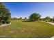 Expansive community park with lush green grass, walking paths, and playground equipment at 22944 E Via Del Oro --, Queen Creek, AZ 85142