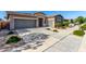 Spacious home featuring a three-car garage, desert landscaping, and a well-maintained driveway at 22944 E Via Del Oro --, Queen Creek, AZ 85142