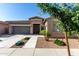 Charming single-story home featuring a well-manicured front yard, a two-car garage, and a welcoming entryway at 22944 E Via Del Oro --, Queen Creek, AZ 85142