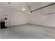 Spacious two car garage with epoxy flooring, overhead lighting, and garage door opener at 22944 E Via Del Oro --, Queen Creek, AZ 85142