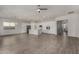 Open-concept kitchen with white cabinets, stainless steel appliances, and a large island, seamlessly integrated into the living area at 22944 E Via Del Oro --, Queen Creek, AZ 85142