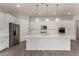 Modern kitchen boasts white cabinets, stainless appliances, quartz countertops, decorative backsplash, and stylish pendant lights at 22944 E Via Del Oro --, Queen Creek, AZ 85142