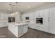 Well-equipped kitchen with white cabinetry, stainless appliances, quartz countertops, designer backsplash, and modern lighting at 22944 E Via Del Oro --, Queen Creek, AZ 85142