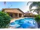 Inviting backyard oasis features a sparkling blue pool, lush landscaping, and a covered patio perfect for outdoor entertaining at 22944 E Via Del Oro --, Queen Creek, AZ 85142