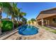 Backyard featuring blue pool, lush landscaping, synthetic grass, and covered patio at 22944 E Via Del Oro --, Queen Creek, AZ 85142