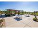 Outdoor recreation area with ping pong tables, shaded seating, and well-manicured landscaping at 22944 E Via Del Oro --, Queen Creek, AZ 85142