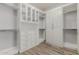 Custom walk-in closet with custom cabinets and shelving, creating functional storage space at 22944 E Via Del Oro --, Queen Creek, AZ 85142