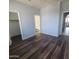 Large bedroom with wood-look floors, two entrances, and a closet at 2323 E Huntington Dr, Phoenix, AZ 85040