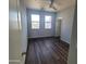 Bright bedroom with natural light, ceiling fan, and hard wood floors at 2323 E Huntington Dr, Phoenix, AZ 85040
