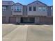 Exterior shot of condo featuring a brown multi-car garage and gray facade in a multi-unit community at 2323 E Huntington Dr, Phoenix, AZ 85040