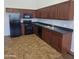 Functional kitchen with dark cabinetry, modern appliances, and tile flooring for easy maintenance at 2323 E Huntington Dr, Phoenix, AZ 85040