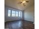 Spacious living room with large windows, ceiling fan, and luxury vinyl flooring at 2323 E Huntington Dr, Phoenix, AZ 85040