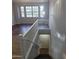 View from the staircase showcasing natural light and modern railing that leads to a door at 2323 E Huntington Dr, Phoenix, AZ 85040