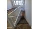 A staircase leads to an upstairs area featuring a large window providing natural light at 2323 E Huntington Dr, Phoenix, AZ 85040