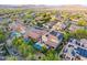 Aerial view of a residential community with houses featuring pools, solar panels, and desert landscape at 26036 N 85Th Dr, Peoria, AZ 85383