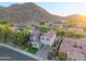 Beautiful aerial view of a home and neighborhood featuring lush landscaping and mountain views at 26036 N 85Th Dr, Peoria, AZ 85383