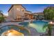 Expansive backyard with a pool, spa, fire pit, covered patio, and outdoor dining area, perfect for entertaining at 26036 N 85Th Dr, Peoria, AZ 85383