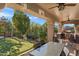Inviting backyard with patio, putting green, outdoor kitchen, pool, and lush landscaping for relaxation at 26036 N 85Th Dr, Peoria, AZ 85383