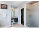 A bathroom showing a walk-in closet, granite sink, and glass-enclosed shower at 26036 N 85Th Dr, Peoria, AZ 85383